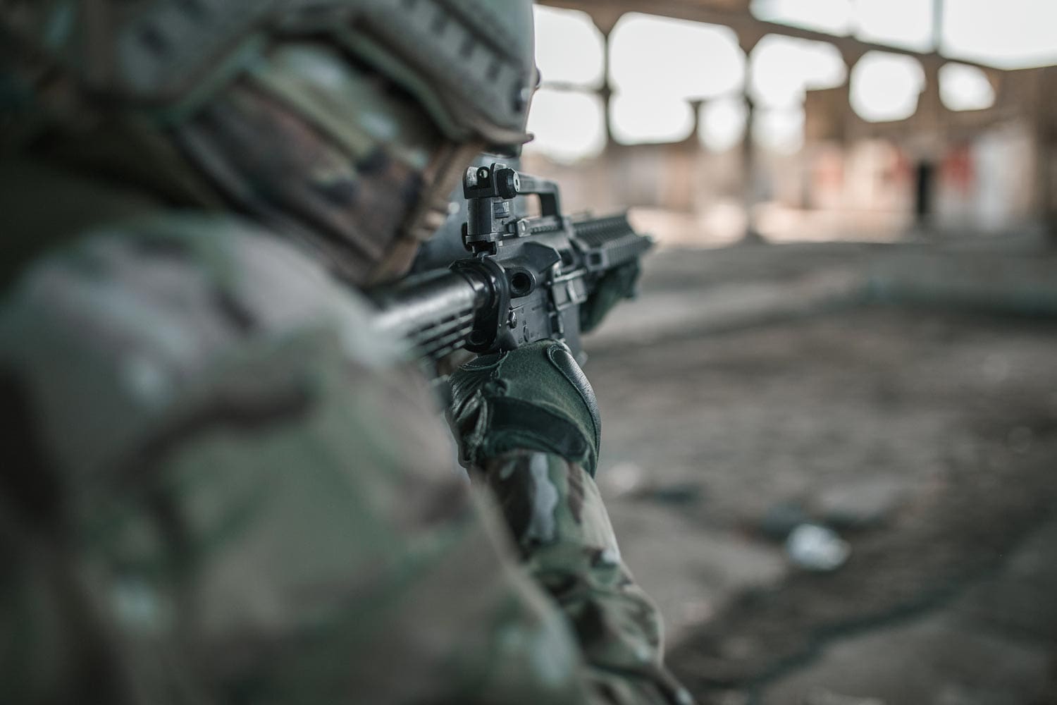 Featured image for 3M Earplug Lawsuit Update, showing a Special Forces soldier in camouflage uniform aiming a rifle in a war zone
